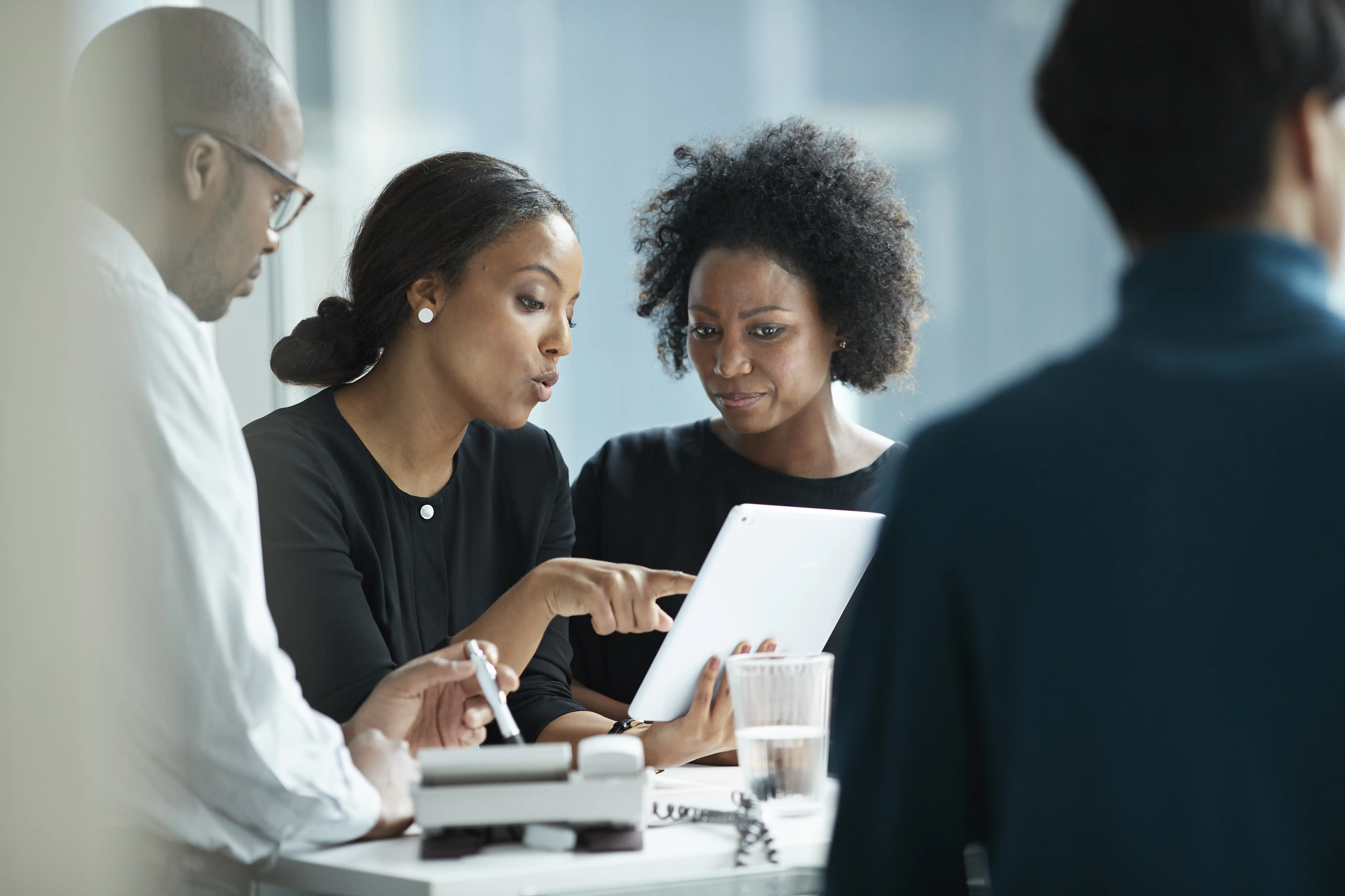 people discussing over a tablet