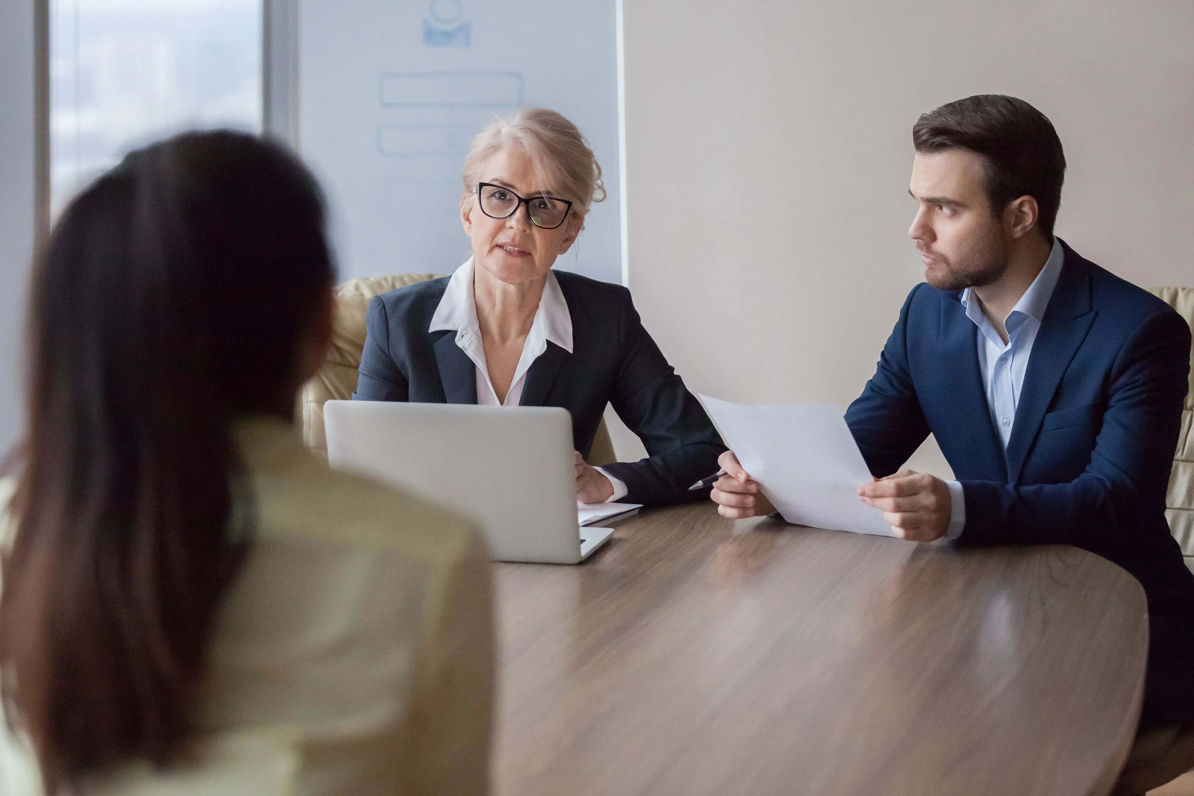 Three people in a meeting room