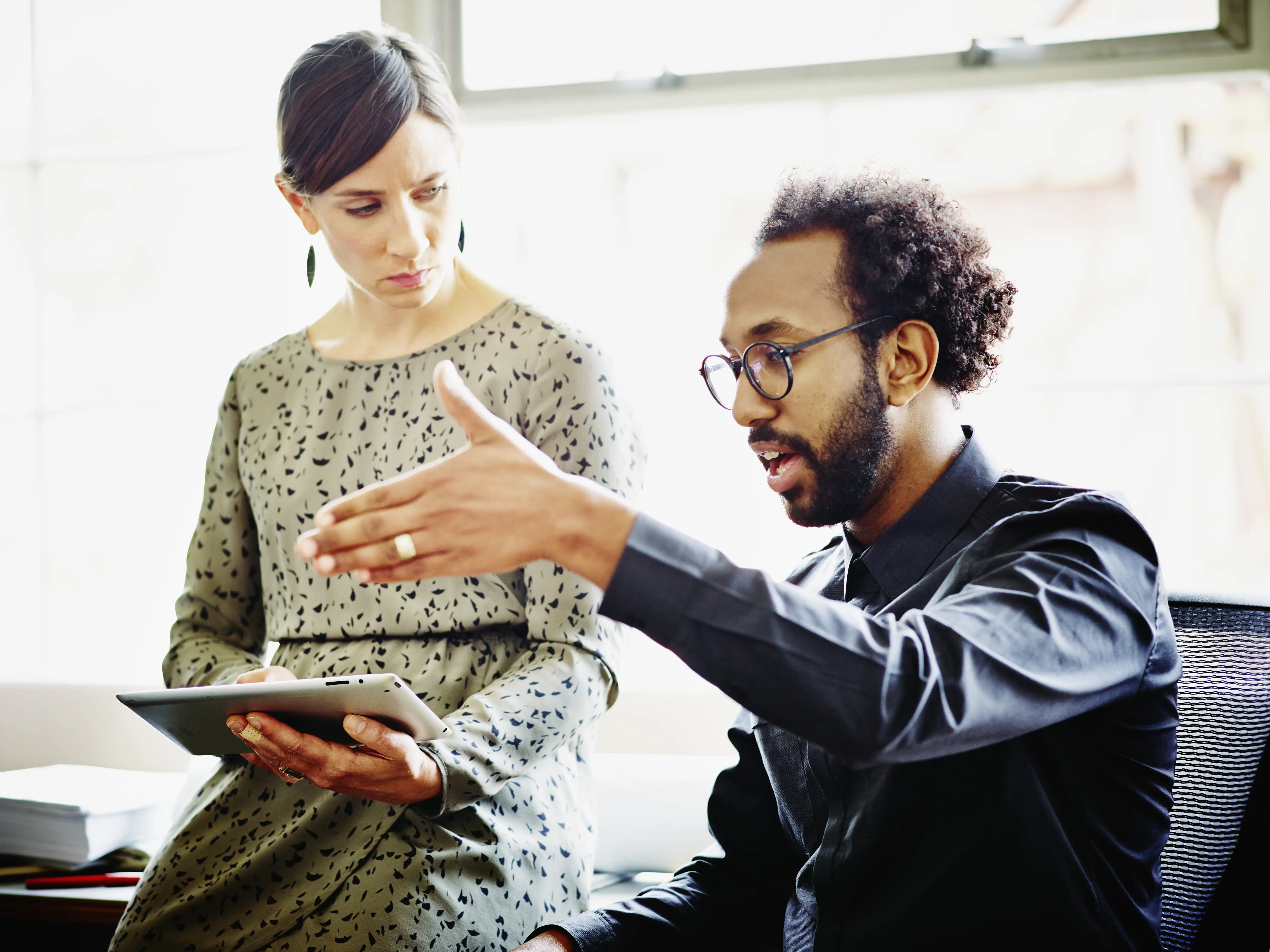 two people discussing in an office